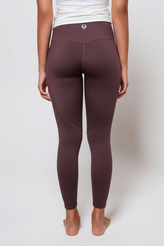 Espresso brown leggings worn by a person on a white background