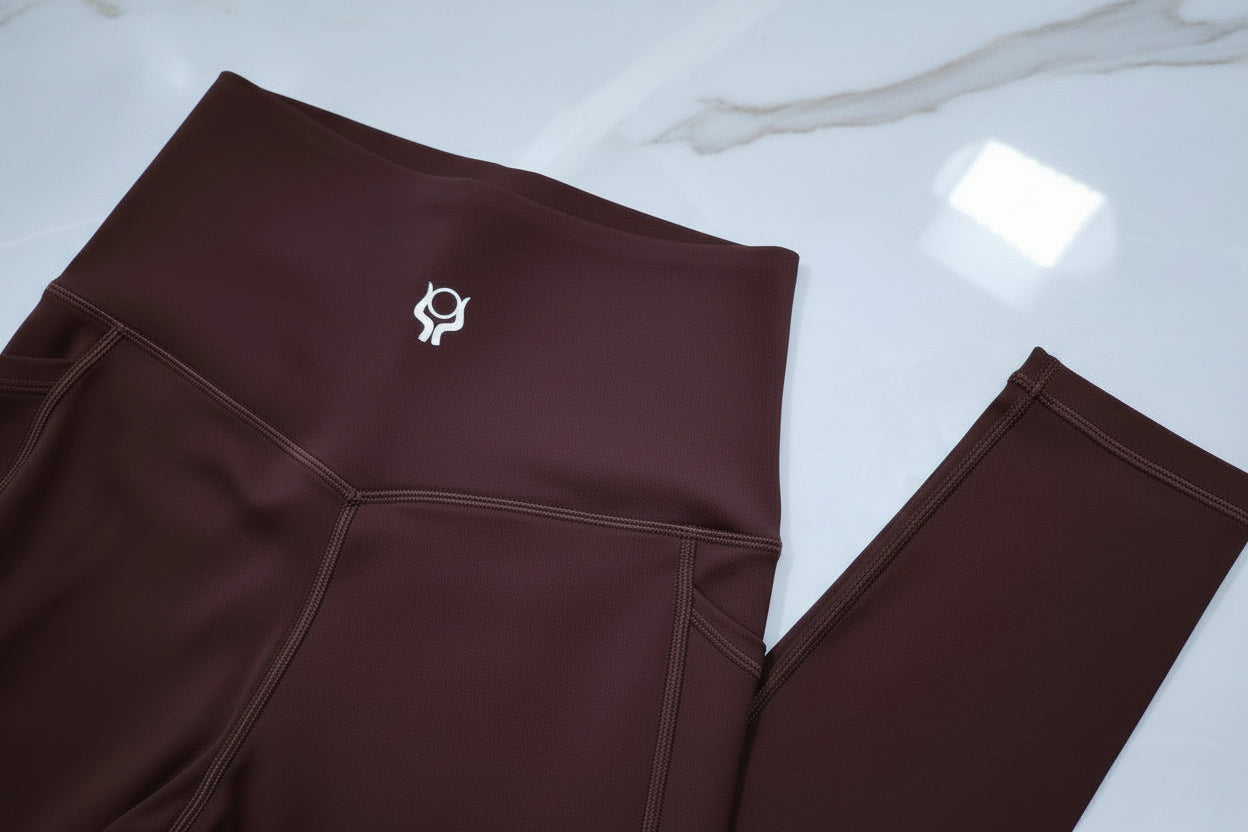 Espresso brown leggings with a logo on a white background