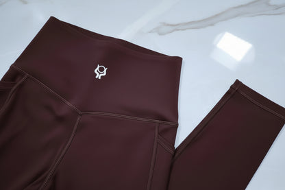 Espresso brown leggings with a logo on a white background
